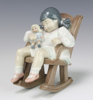 A Lladro figure of a young girl asleep in a rocking chair with a doll no.5448 12cm 