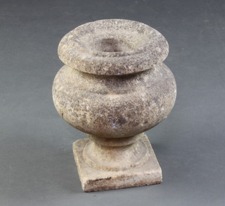 A circular carved and weathered marble garden urn raised on square foot 30cm x 23cm diam. 