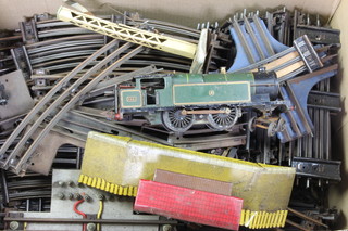 An O gauge tank engine, a large collection of O gauge rails and a tin plate station 