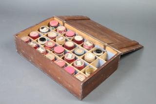 A wooden box containing a collection of various Edison phonograph cylinders 