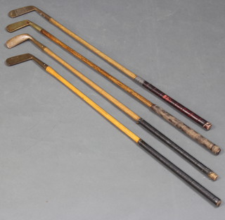 A Halley Hickory shafted golf putter, a Wyandelle Brand ditto, a golf putter the head marked H with crossed sword (chip to head), 1 other putter marked "Putter"