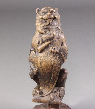 A Victorian carved wooden newel post finial in the form of a rampant lion 36cm x 10cm x 10cm 