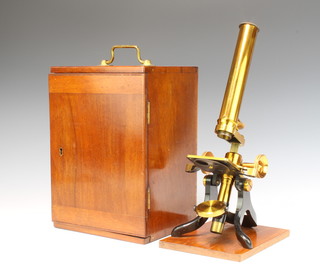 A student's 19th Century brass single pillar microscope contained in a mahogany case, the base fitted a drawer containing 21 glass slides 
 