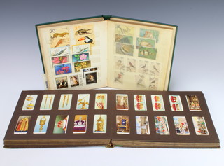 A stock book of world stamps including GB with two penny reds and other stamps together with a cigarette card album of Churchmans footballers 