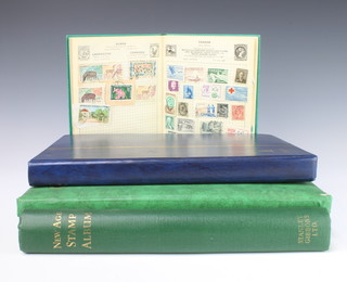 A green Improved stamp album of world stamps - France, China, Canada, Burma, Belgium, Australia, a blue stock book of Australian used stamps  Victoria to Elizabeth II, a green stock book of Elizabeth II used commonwealth stamps, a green New Age stamp including a small collection of USA stamps