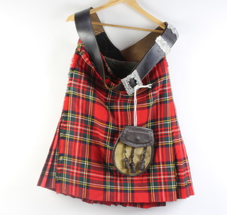 A piper's black leather cross belt, a leather sporran and a kilt 