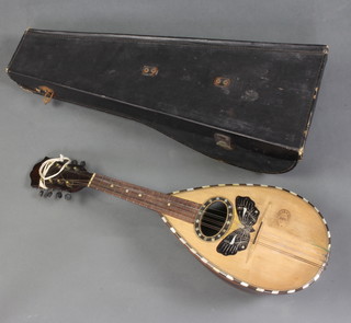 An 8 stringed mandolin, the front marked Mario Casella Batania complete with carrying case 