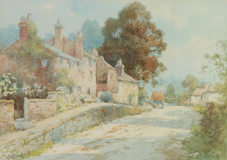 L Mortimer, watercolour, signed, a West Country street scene with a hay cart before buildings 25cm x 35cm 
