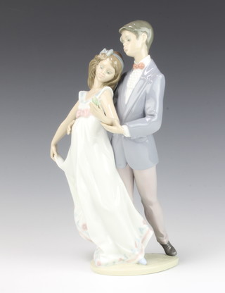 A Lladro group of a couple, the lady holding a flower  no. 7642 28cm, boxed