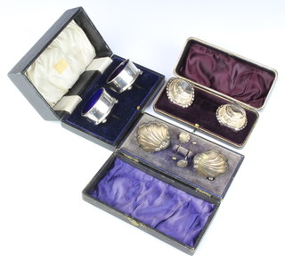 A pair of Edwardian silver shell shaped salts Chester 1906, a pair of Victorian round ditto Birmingham 1894 and a pair of oval silver ditto Birmingham 1919, all cased, 74 grams  