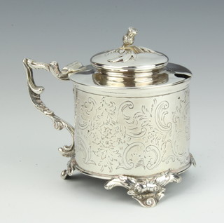 A Victorian silver circular mustard with chased scroll decoration and armorial raised on scroll feet with blue glass liner 9.5cm, 142 grams 