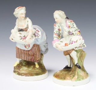 A pair of German table salts in the form of a standing Rococo lady and gentleman on rustic bases 22cm 