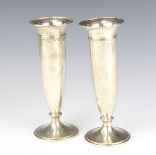 A pair of silver posy vases with panelled sides 18cm, Birmingham 1923