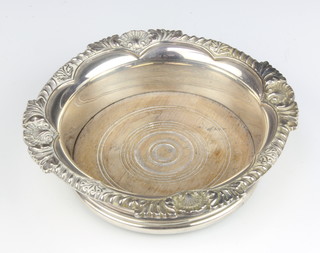 A silver wine coaster with scroll and shell rim Sheffield 1964, 16.5cm