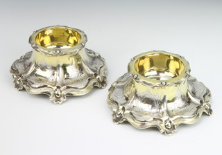 A pair of Victorian cast and chased silver table salts with floral and scroll decoration London 1847, 344 grams, 13cm, maker Charles Thomas Fox and George Fox 