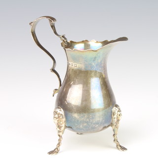 A silver baluster cream jug with lion knees and pad feet, Birmingham 1912, 12cm, 107 grams