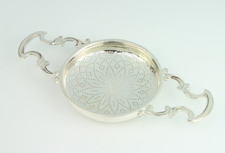 A Georgian silver strainer with pierced handles and geometric decoration, makers mark IWTB, 96 grams, 20cm 