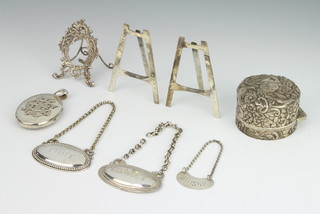 A Victorian repousse silver toilet bottle lid London 1895, 3 miniature easels, 3 spirit labels and a locket 165 grams 