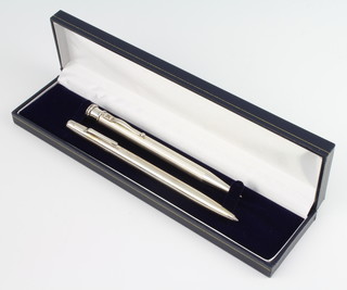 A silver ballpoint pen (cased), 1 other 