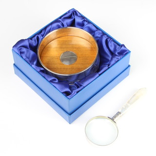 A modern silver coaster 9.5cm, boxed and a silver and mother of pearl magnifying glass