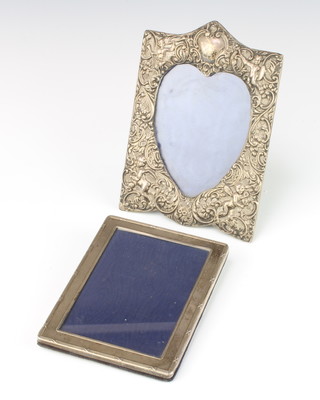 An Edwardian repousse silver heart shaped photograph frame decorated with nymphs and scrolls Birmingham 1900, 19cm, a rectangular ditto 