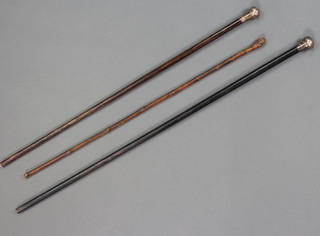 A silver mounted walking cane, 1 other and a stick 