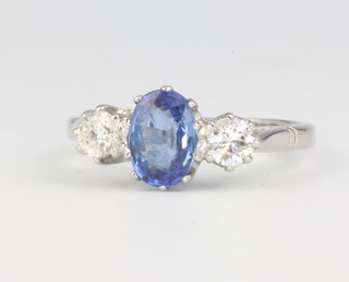 A platinum 3 stone sapphire and diamond ring, the central oval cut stone approx. 1ct flanked by diamonds each 0.25ct, size O 1/2