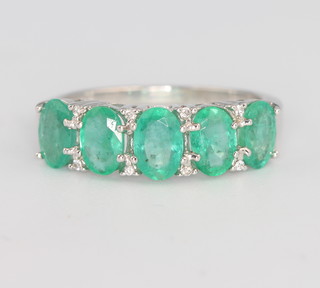 A 9ct white gold emerald and diamond ring size N 
