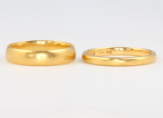 A 22ct yellow gold wedding band 3.5 grams, size K, a ditto 2.5 grams size M 