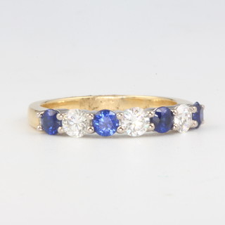 An 18ct sapphire and diamond ring, the diamonds approx. 0.6ct, the sapphires 0.4ct, size M 