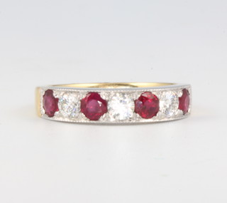 An 18ct yellow gold ruby and diamond half hoop ring, the diamonds approx. 0.6ct, the rubies approx. 0.6ct, size L 1/2