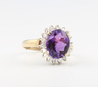 A yellow gold oval amethyst and diamond cluster ring size L 