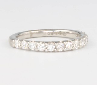 A platinum diamond half eternity ring size M, set 13 diamonds 