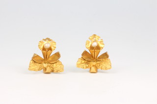 A pair of high carat pearl set floral ear studs 3.7 grams
