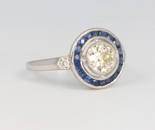An 18ct white gold Art Deco style sapphire and diamond cluster ring, the centre diamond approx. 0.92ct, size N 