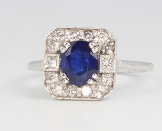 An 18ct white gold Art Deco style sapphire and diamond cluster ring, centre stone approx. 0.75ct surrounded by brilliant cut diamonds, size N 1/2