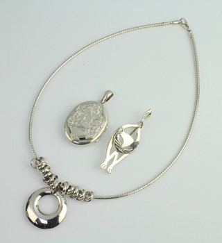 A silver necklace, brooch and locket