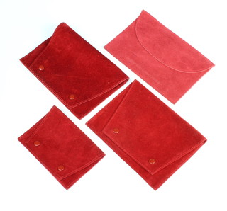 Three red suede Cartier pouches and 1 other 