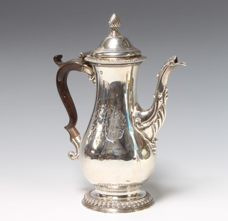 A George III silver coffee pot of baluster form with acorn finial and acanthus spout, having a fruitwood handle, London 1772, 846 grams gross, 26cm, maker FC 