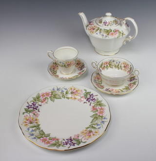 A Royal Albert Country Lane tea and dinner service comprising 6 cups, 6 saucers, 1 sugar bowl, 1 slop bowl, 1 cream jug, 1 milk jug, 6 tea plates, 6 dessert plates, 1 cake plate, 1 dish, 1 tea pot, sauce boat and stand, 6 dinner plates, 6 two handled soup bowls and saucers 
