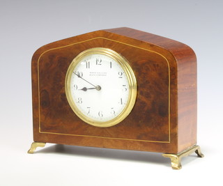 A 1920's French bedroom timepiece with enamelled dial and Arabic numerals contained in an arched inlaid walnut case, the dial marked Barron Clarke and Sons 