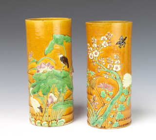A near pair of Chinese tan glazed faux bamboo vases decorated with birds amongst trees 28cm and 28.5cm 