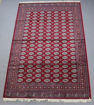A red ground Belgian cotton Bhokara style carpet with numerous octagons to the centre within a multi-row border 300cm x 200cm  