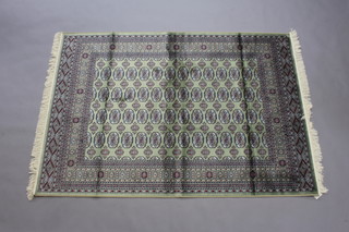 A green ground Belgian cotton Bokhara style carpet with numerous octagons to the centre within a multi row border 200cm x 140cm 