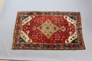 A green, ground and blue ground Malayer rug with central medallion within a 3 row border 225cm x 136cm 