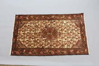 A brown and white ground Persian Brojero rug with central medallion within a 3 row border 158cm x 93cm 