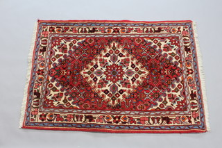 A red and white ground Toyserkan rug with central medallion within multi row border 150cm x 105cm