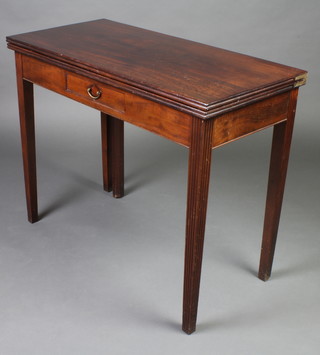 A George III mahogany tea table fitted a frieze drawer and raised on square reeded supports 73cm h x 91cm w x 44cm d 