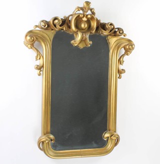 A shaped plate mirror contained in a gilt painted carved wooden frame 91cm x 68cm 