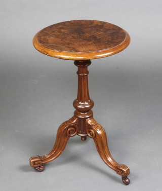 A Victorian circular figured walnut wine table raised on a turned and fluted column with tripod base 58cm x 37cm 